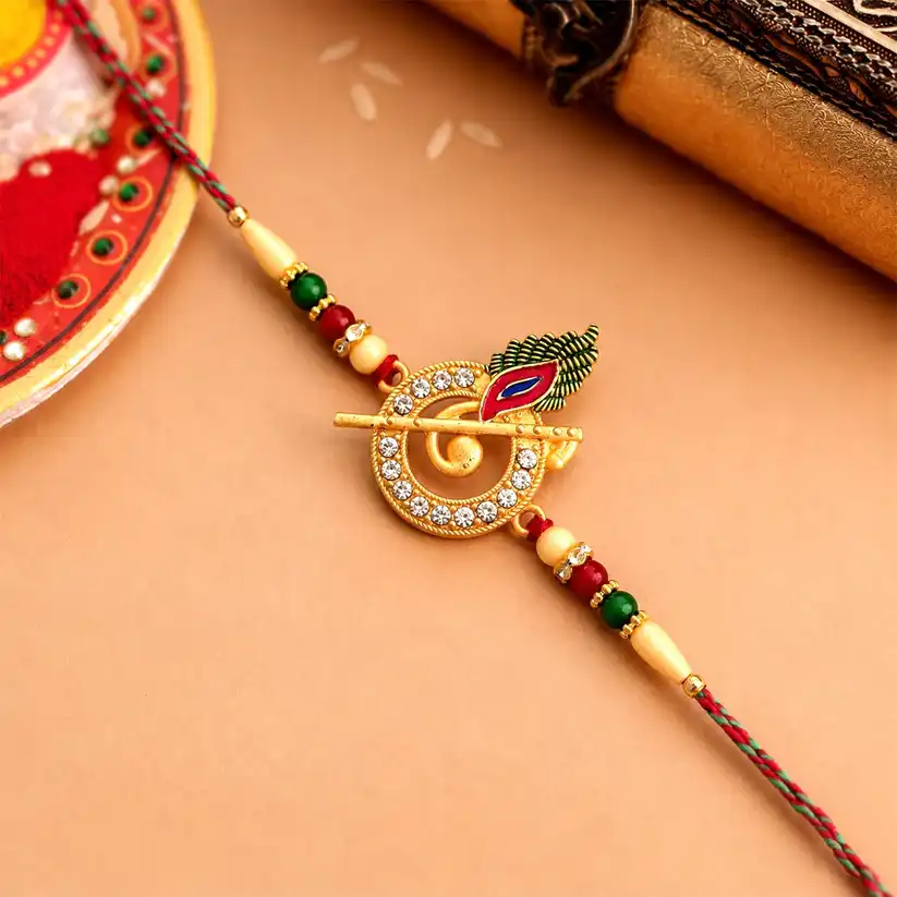 Krishna Flute Rakhi with Stone-Studded Peacock Feather Design